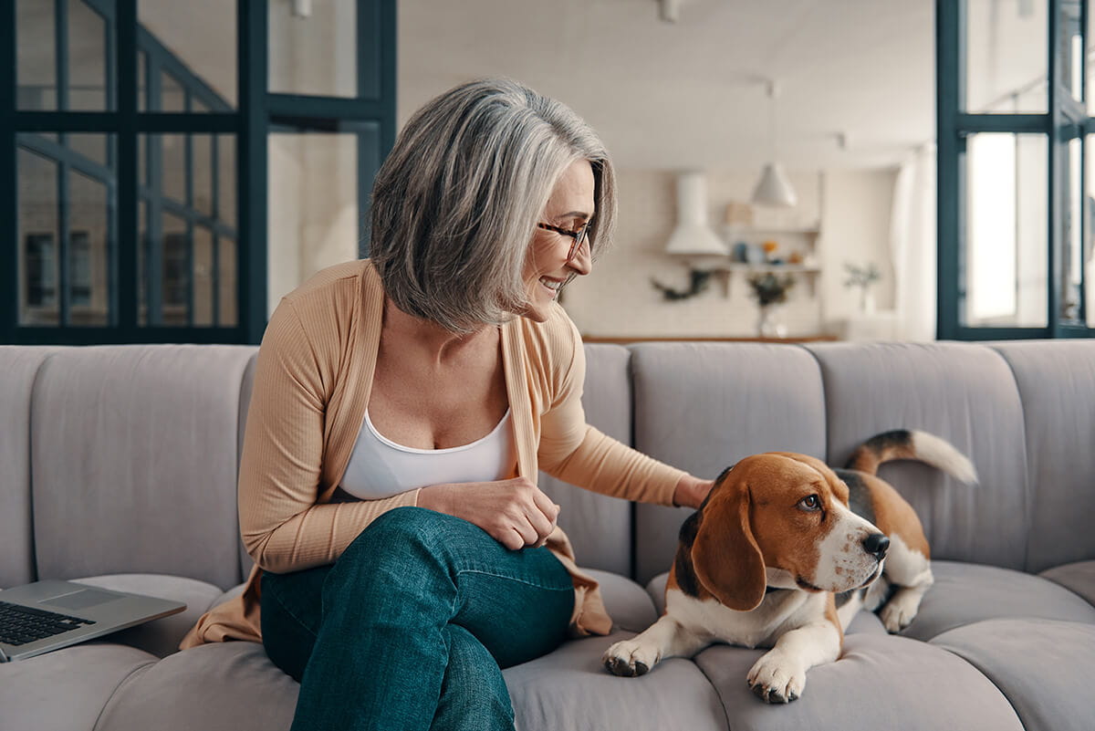 Woman with dog; breast specialists at Ascension St. Vincent's Cancer Care deliver advanced care and support.