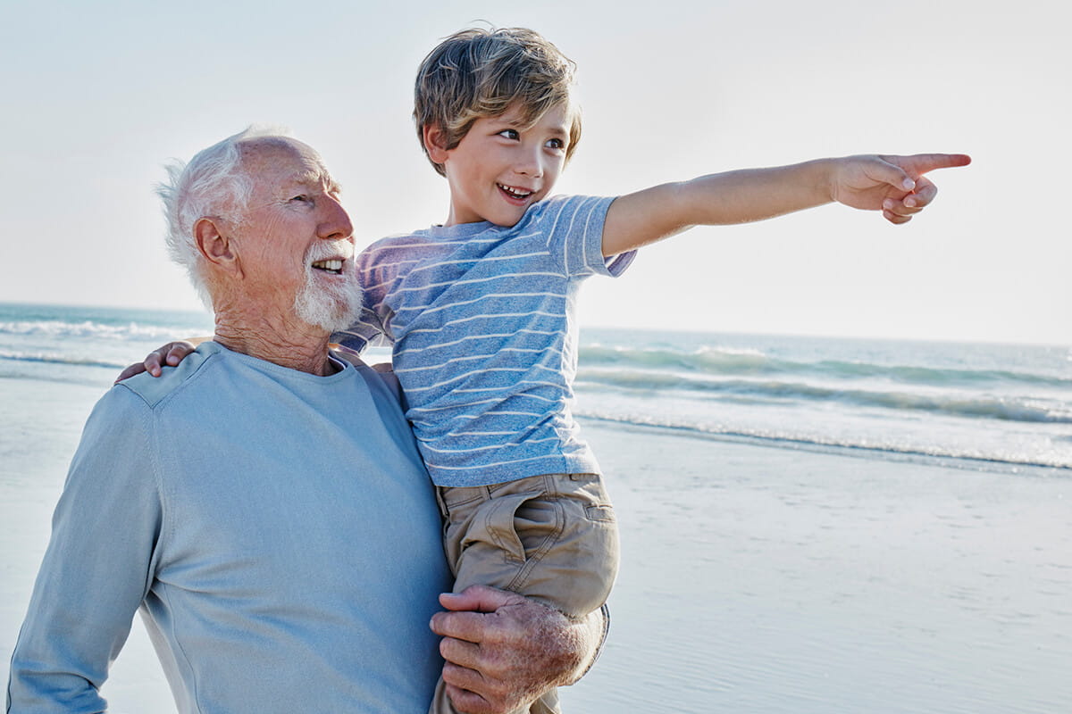 Man carrying a boy; ENT specialists at Ascension St. Vincent's Cancer Care deliver advanced care for head and neck cancer.